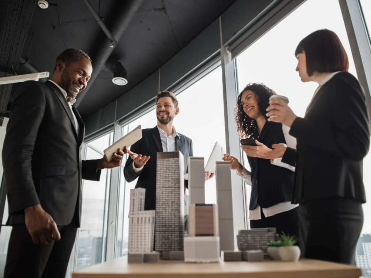 Real estate team reviewing property models in a modern office
