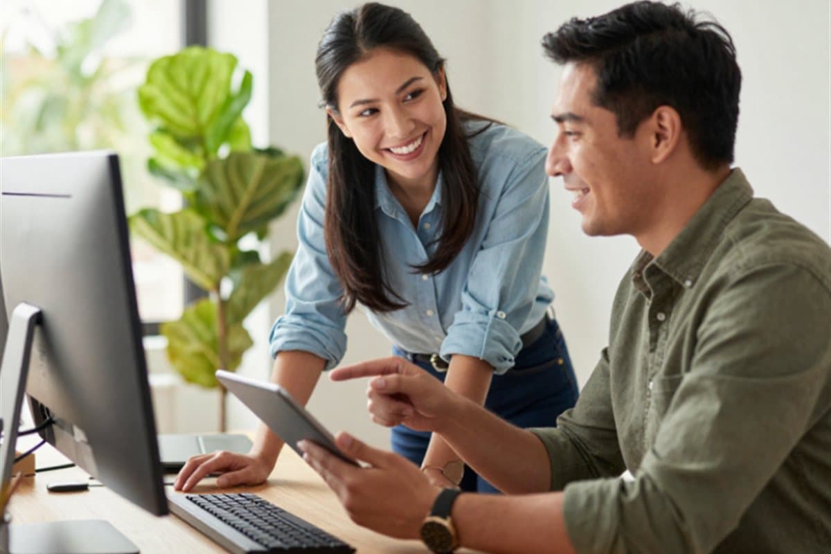IT professional helping a colleague at their desk